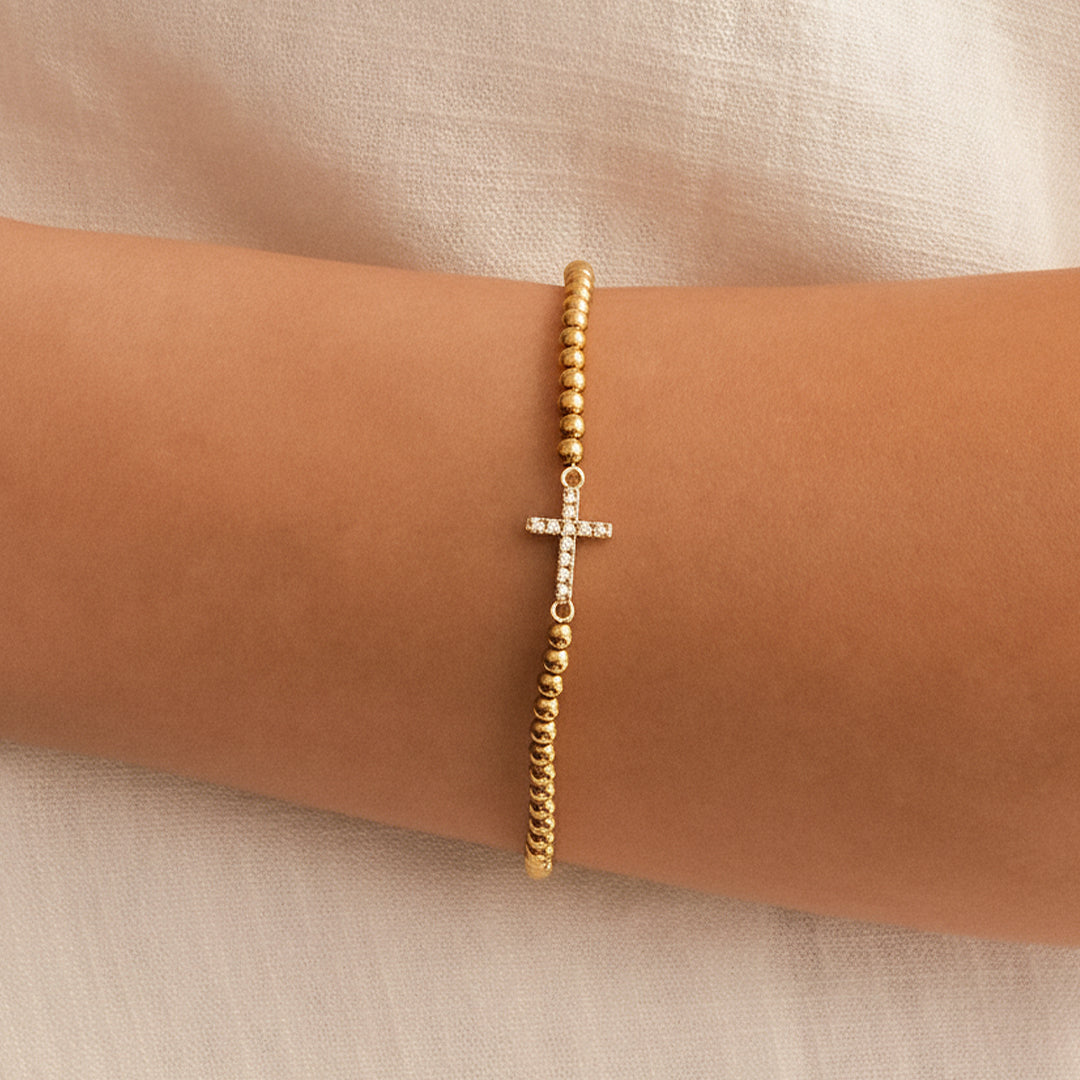 Gold Beaded Cross Stretch Bracelet, worn on a model